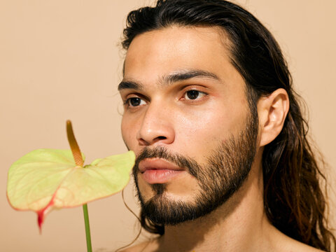 latino man portrait with flower