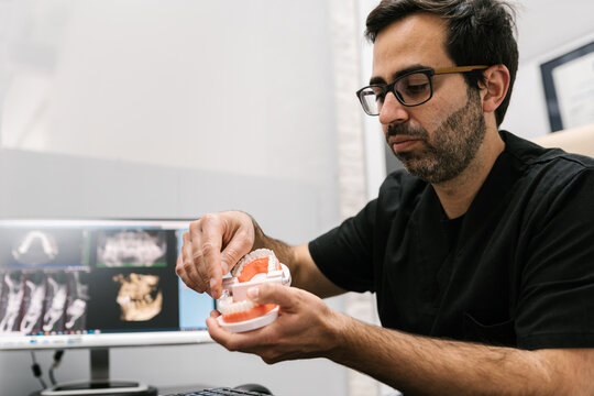 Dentist Working in his Office