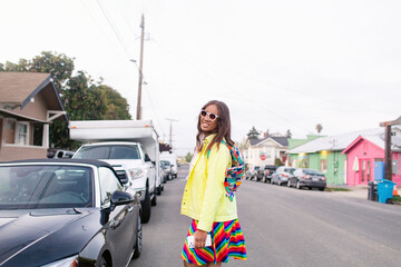 Cheerful Fijian female walking on suburban street