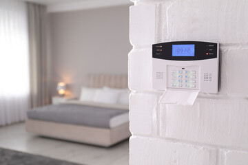 Home security system on white wall indoors, space for text