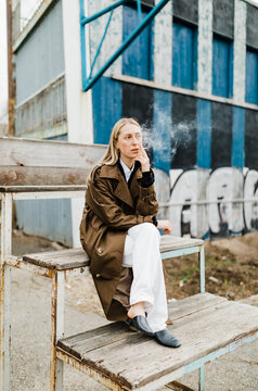 street portrait of blond woman smoking
