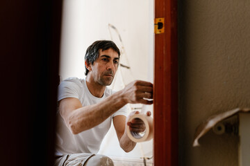 Mason painter making repairs to a house.