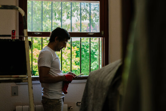 Hard Working Bricklayer Using Phone