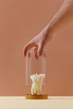 Man covering candle with male shape