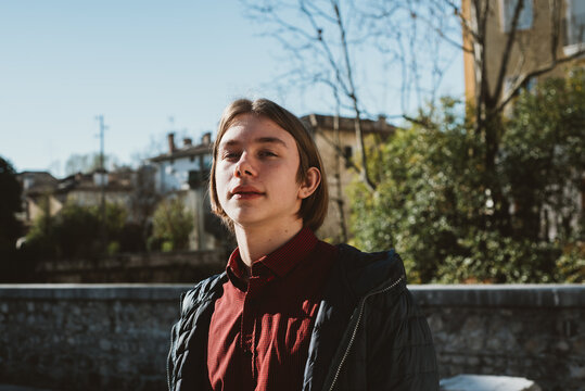 A young man in old italian town camera aware