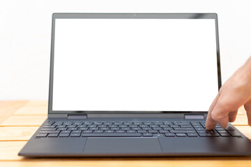 Hand operating the numeric keypad of a laptop with the blank screen (available)