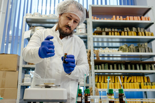 Cosmetic chemist creating products in laboratory 