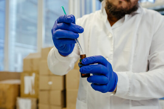 Cosmetic chemist creating products in laboratory 