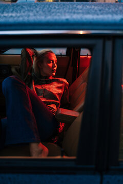 Lonely woman in dark car cabin