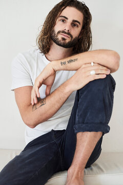 Portrait of a young bearded man with long hair