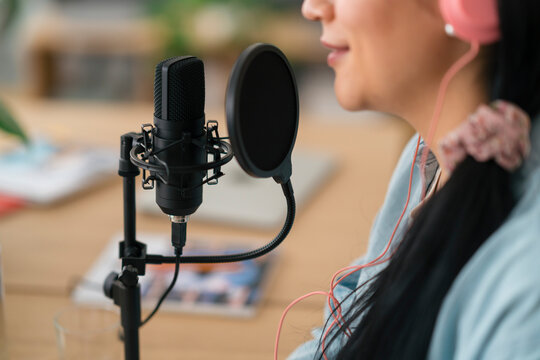 Anonymous woman recording podcast in studio