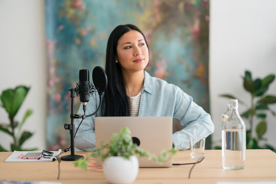 Content woman in studio for recording podcast