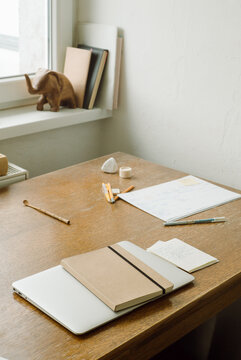 Workbooks and diary on the table near the window