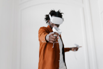 Cheerful man in VR headset playing video game