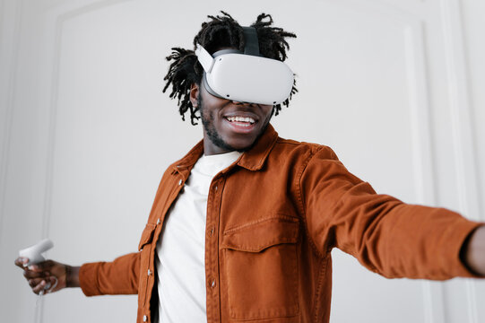 Cheerful man in VR headset playing video game