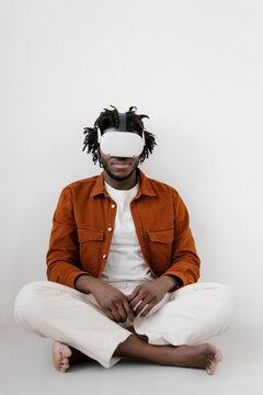 Content black man meditating in VR glasses
