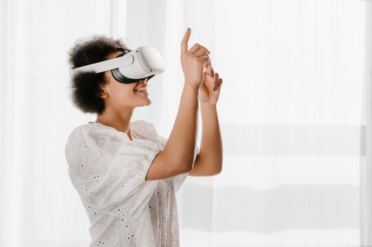 Black female in VR glasses interacting with cyberspace