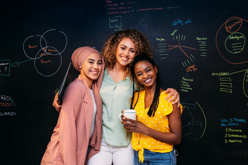 Happy multiethnic colleagues posing in modern office