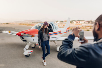Young couple ready to take a flight in a small plane