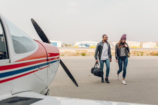 Young couple ready to take a flight in a small plane