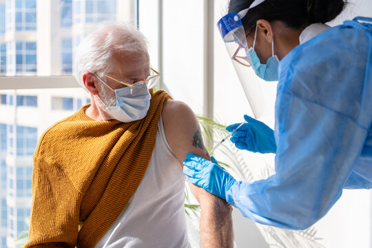 Elder gentleman getting vaccinated.