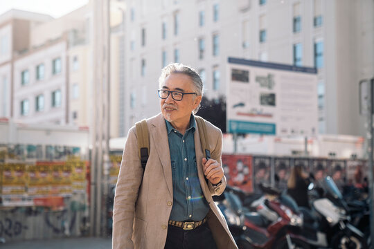 Happy Asian Man Exploring the City
