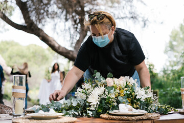 Decorator setting table for wedding celebration