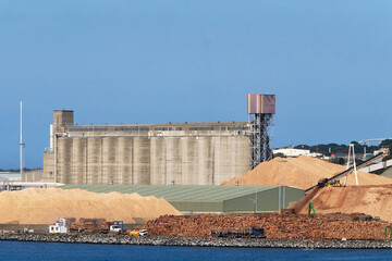 Wheat silos and logging storage at port ready for export