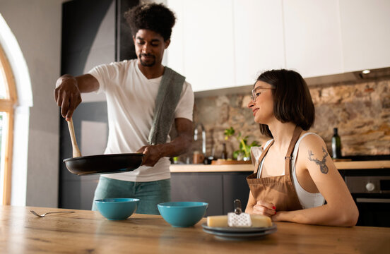 Husband serving the  food to his wife at home