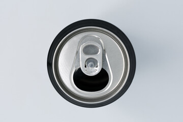 Detail shot from above of the spout of an aluminum can on a white background and selective focus.