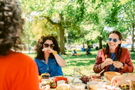 Woman laughing enjoying picnic outdoors