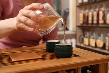 Master conducting traditional tea ceremony at table, closeup