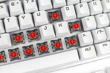 Mechanical keyboard switch. Red switches of the gaming mechanical keyboard, selective focus. Repair...