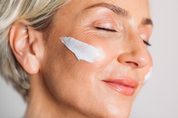 Woman with Facial Cream Smiling 