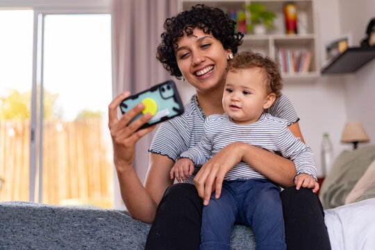 Young mom with her baby in a videocall