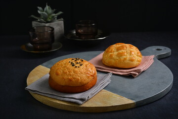 freshly baked Hong Kong Macau butter crispy skin polo bun in dark background pastry halal menu