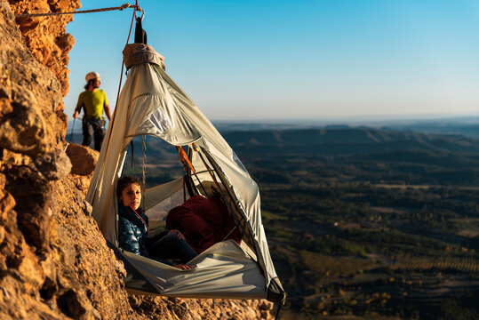 Climbers resting inside a wall portaledge in height