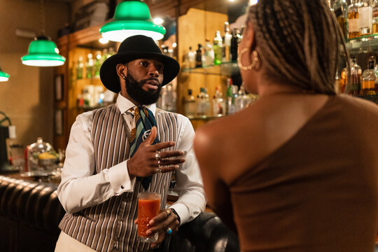 Black couple talking in pub