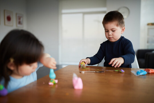 Mixed Race Chinese Siblings Play With Play Dough Together