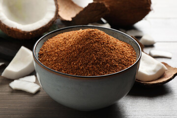 Natural coconut sugar in ceramic bowl on wooden table