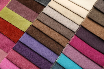 Fabric samples of different colors as background, top view