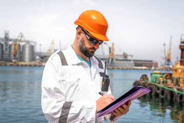 Seaman or port worker fills checklist