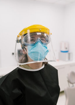 Physician wearing protective goggles in a clinic