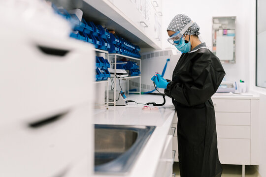 Dentist doing a dental implant with a drilling machine