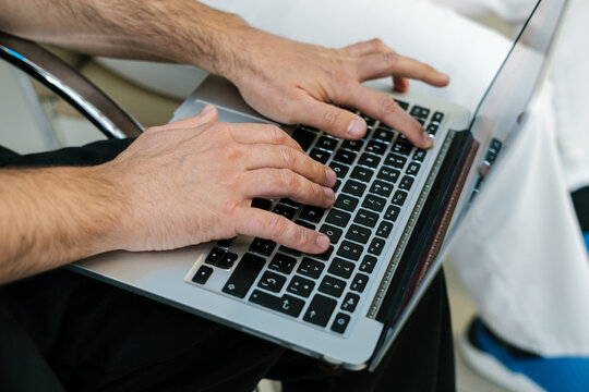 Anonymous hands using a laptop computer