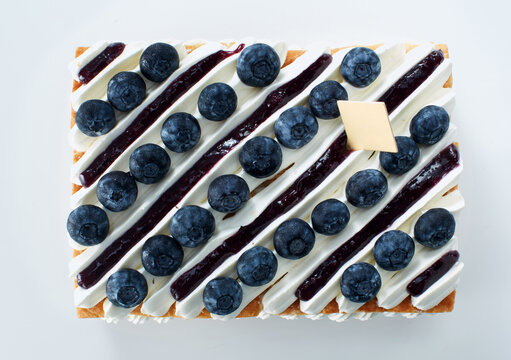 Home-made cakes, patterns of dress angles. On white dining table background