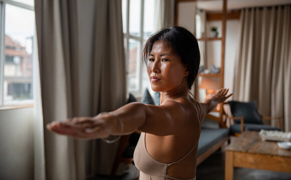 Woman practicing yoga at home