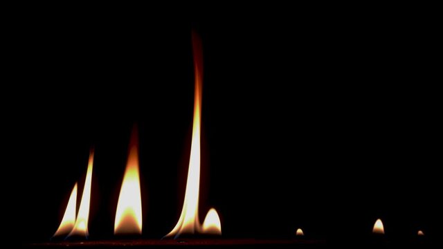 B roll of Close-up of flames burning slow motion background footage. Flames fire on black background. Burning fire. Bonfire. 