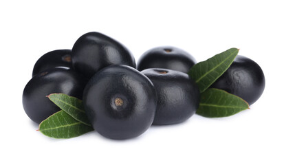 Pile of fresh ripe acai berries and green leaves on white background