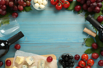 Fototapeta na wymiar Frame of tasty red wine and snacks on light blue wooden table, flat lay. Space for text